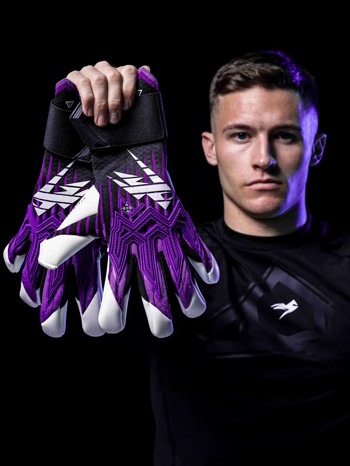 Portero sosteniendo guantes Kaliaaer morados